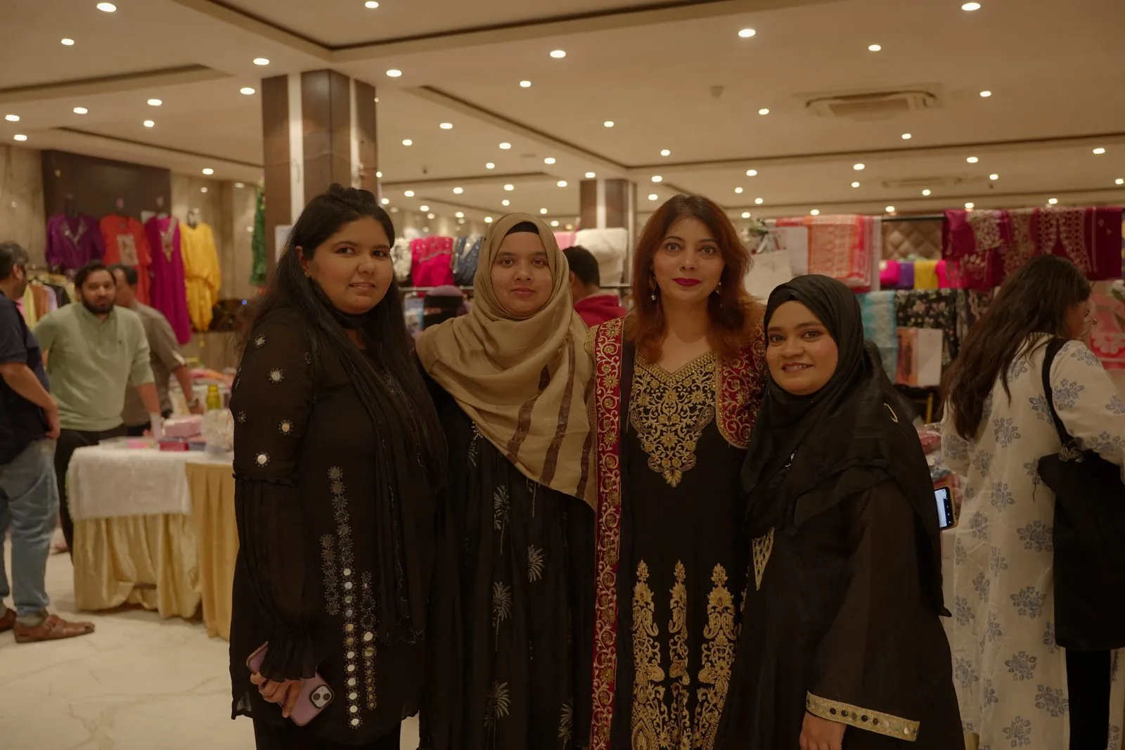 Founder Atoofa Khushnood with exhibitors on the AAINA 2026 stall floor in Kolkata